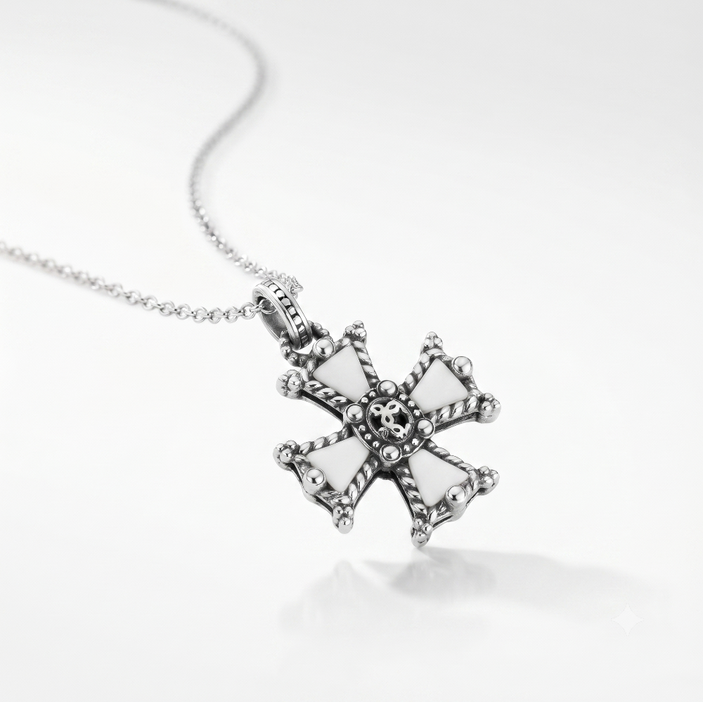A silver cross pendant necklace with white enamel inlays and a detailed skull motif at the center, shown on a clean white background.