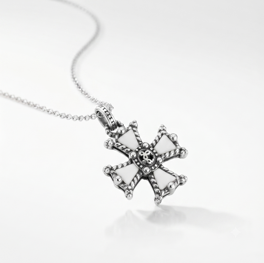 A silver cross pendant necklace with white enamel inlays and a detailed skull motif at the center, shown on a clean white background.