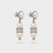 A pair of silver and gold drop earrings featuring white freshwater pearls, with a central band of pavé-set clear stones, shown on a light gray background.