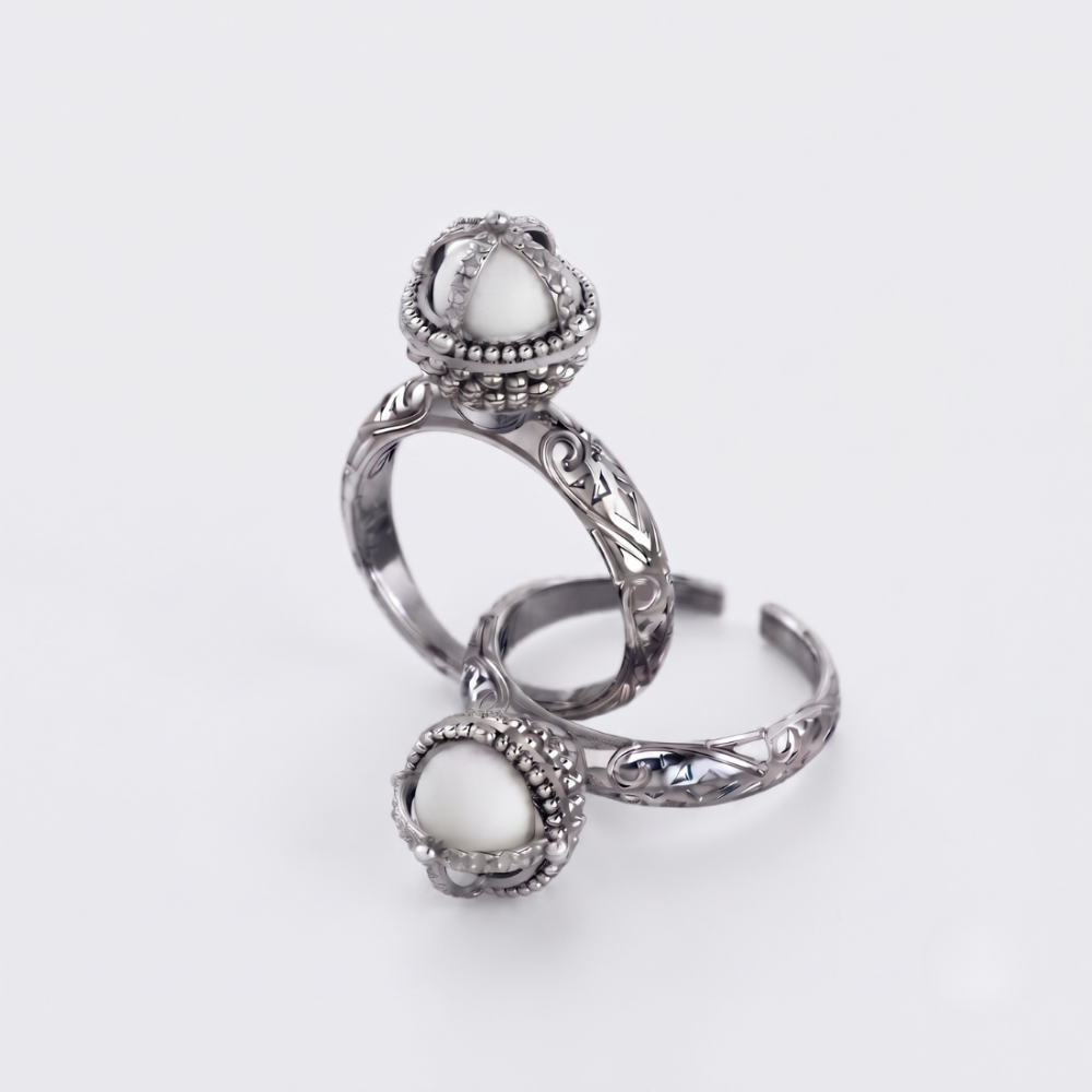 A pair of silver-toned adjustable rings with oval white stone settings, displayed on a clean white background.