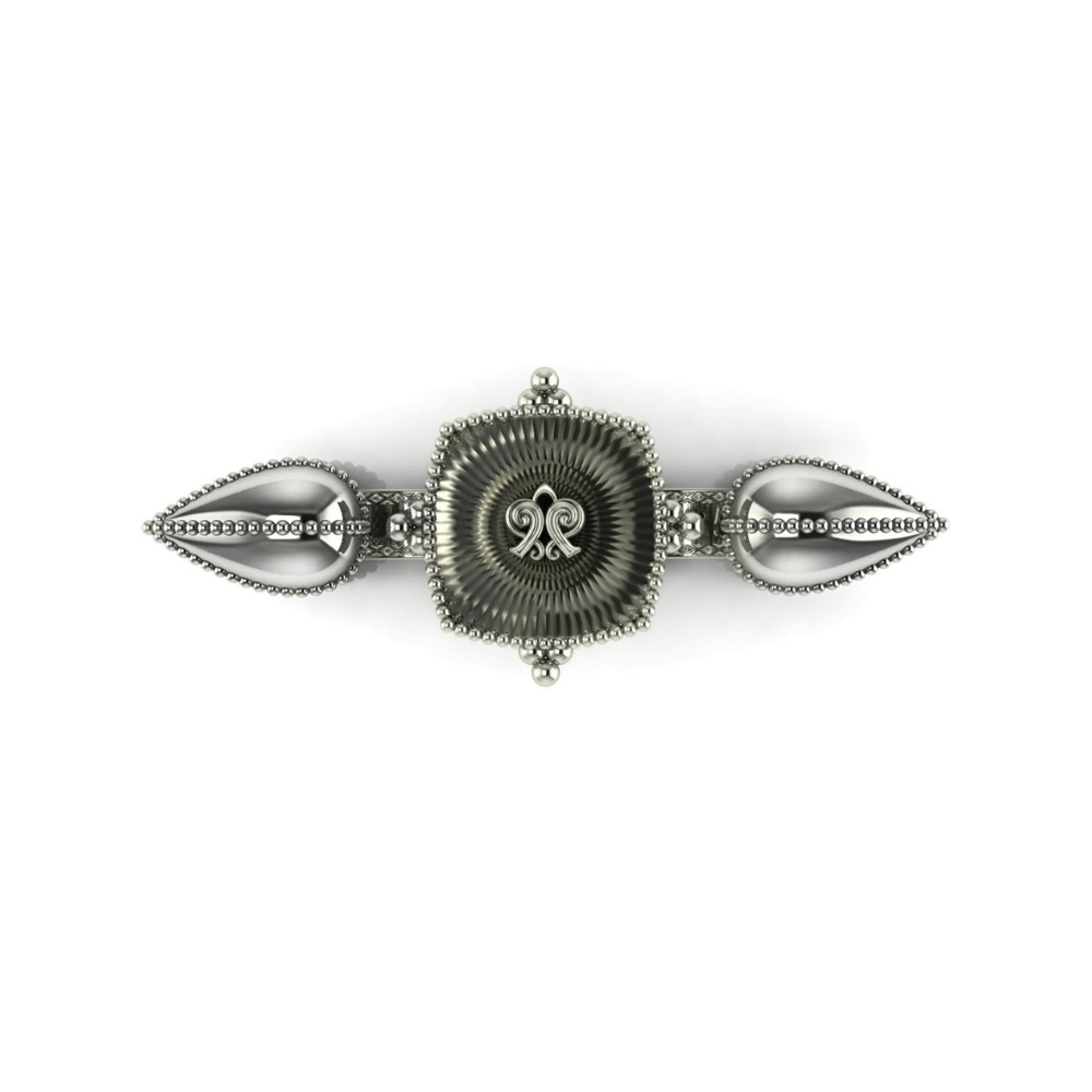 Silver barrette with intricate design on a white background