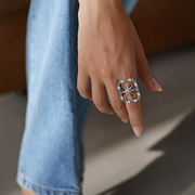 Hand wearing a star ring with a blurred background