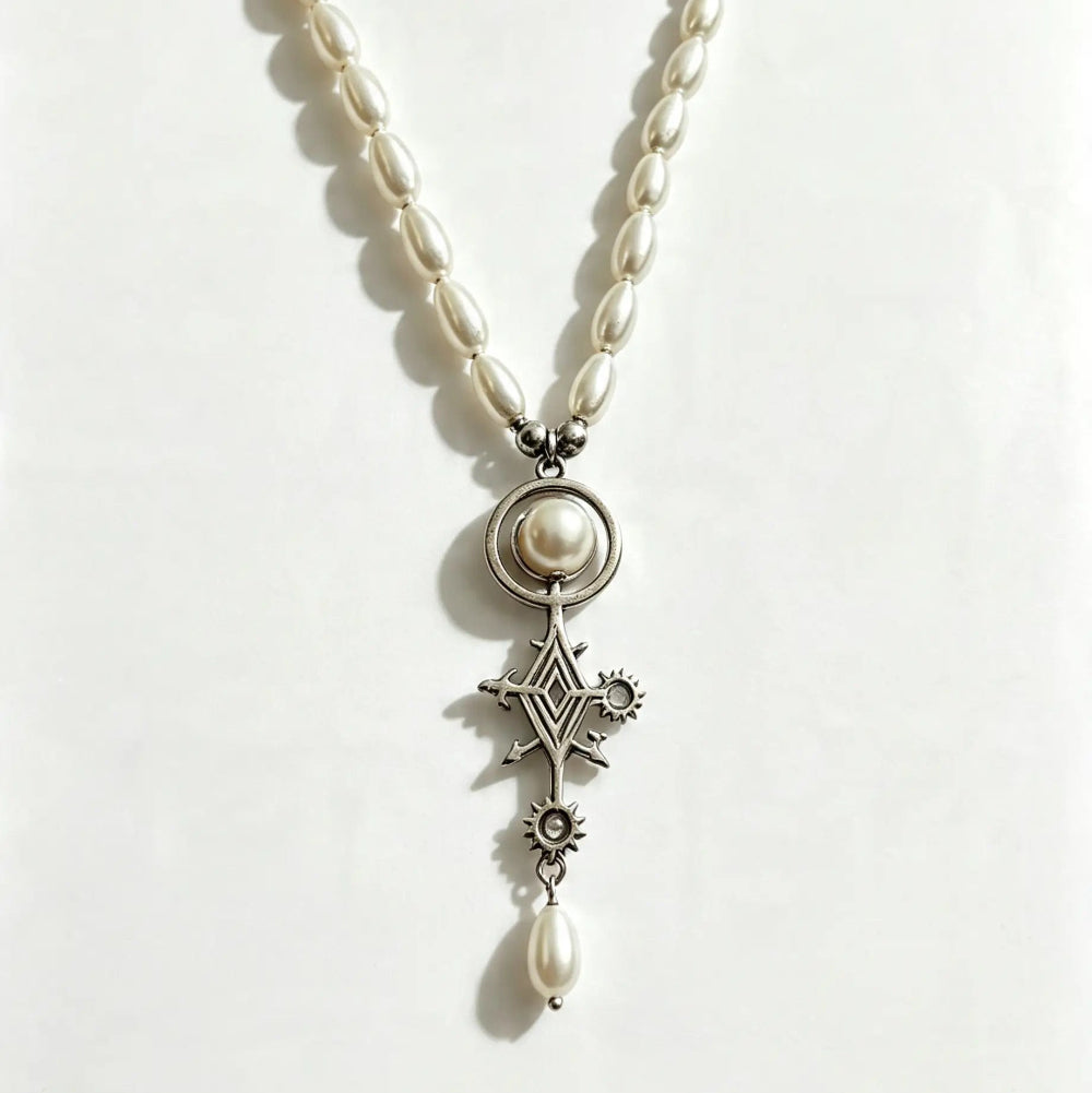 A pearl and silver pendant necklace featuring a central round pearl, a silver Maltese cross, a small star, and a dangling pearl bead, displayed on a plain white background.