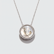 A silver pendant necklace featuring a circular bezel-set shell inlay with a small gold penguin motif, suspended from a delicate silver chain against a light gray background.