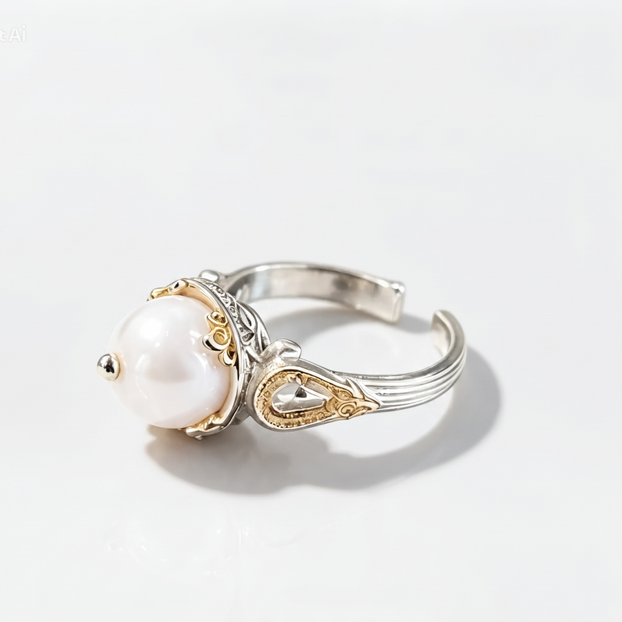 A silver and gold adjustable ring featuring a large white pearl, photographed on a clean white background with a soft shadow.