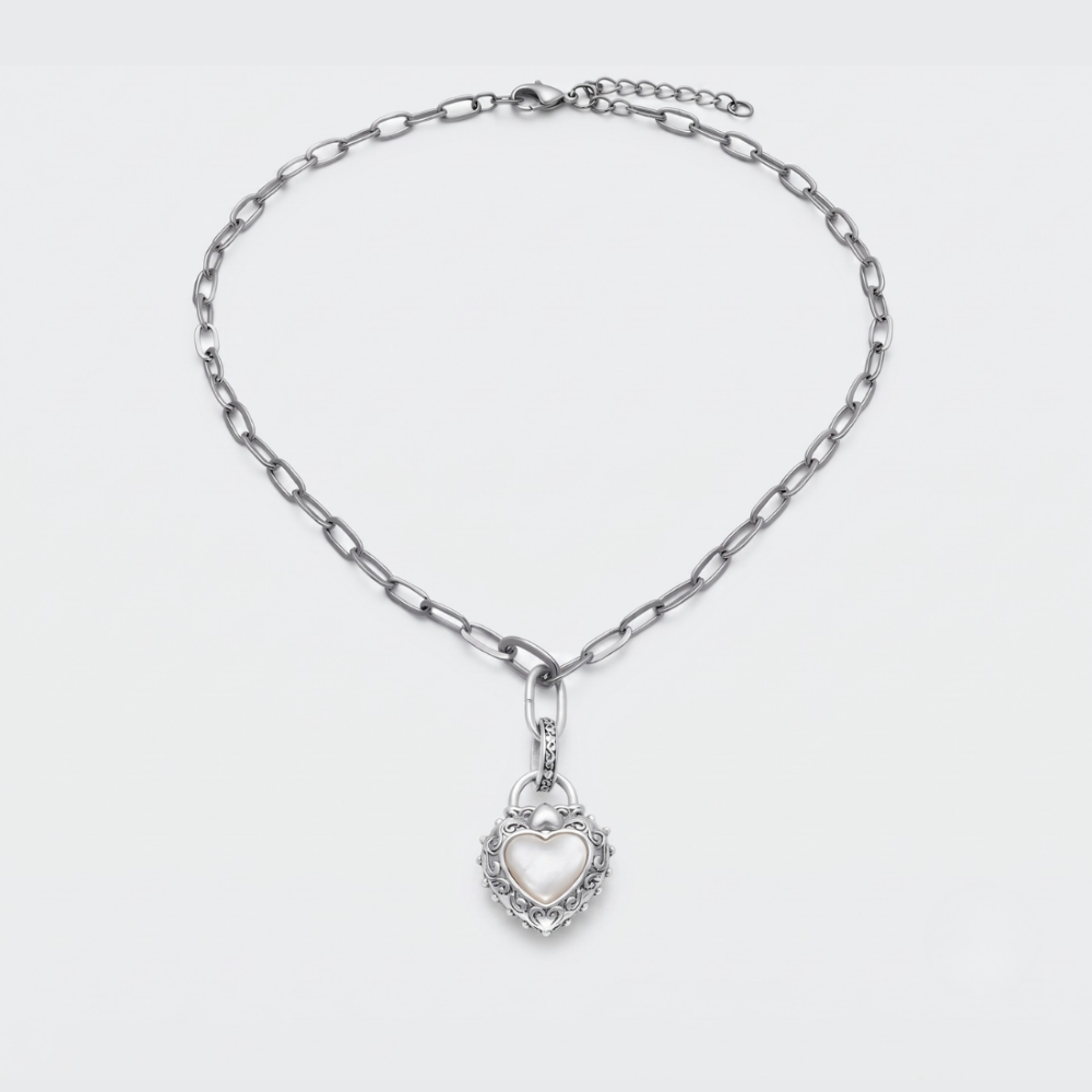 A silver-toned chain necklace with a heart-shaped pendant, displayed on a clean white background.