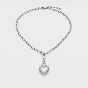 A silver-toned chain necklace with a heart-shaped pendant, displayed on a clean white background.