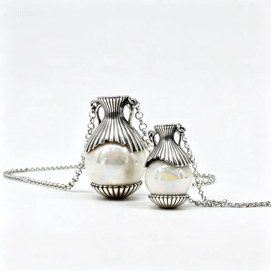 Two silver urn-style pendant necklaces with white pearl-like beads, displayed on a clean white background.