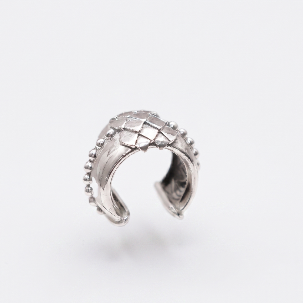A silver-toned textured ring with a basketweave pattern and small bead accents on the outer edges, shown on a clean white background.