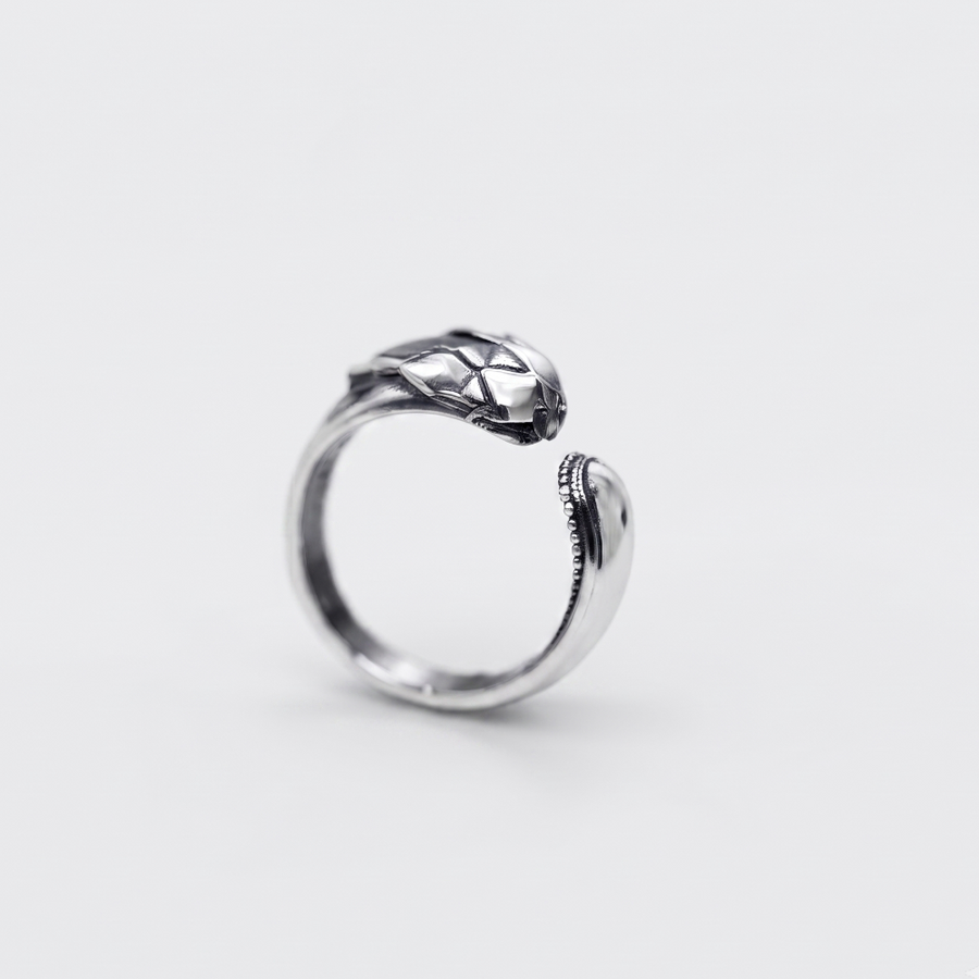 A silver snake ring with a textured, raised head and an open adjustable band, shown on a light gray background.