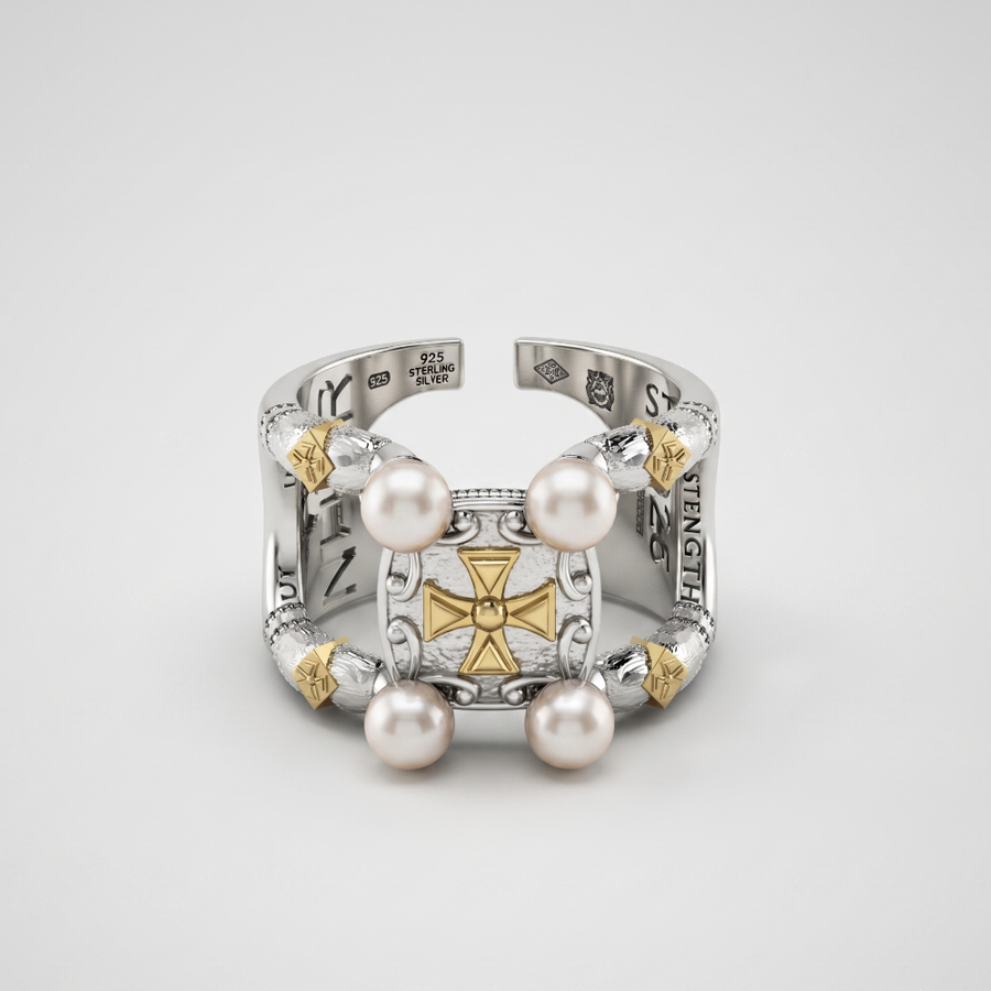 A silver-toned open cuff ring featuring a central gold-toned cross motif, accented with four white pearls and small gold-toned details, photographed on a light gray background.