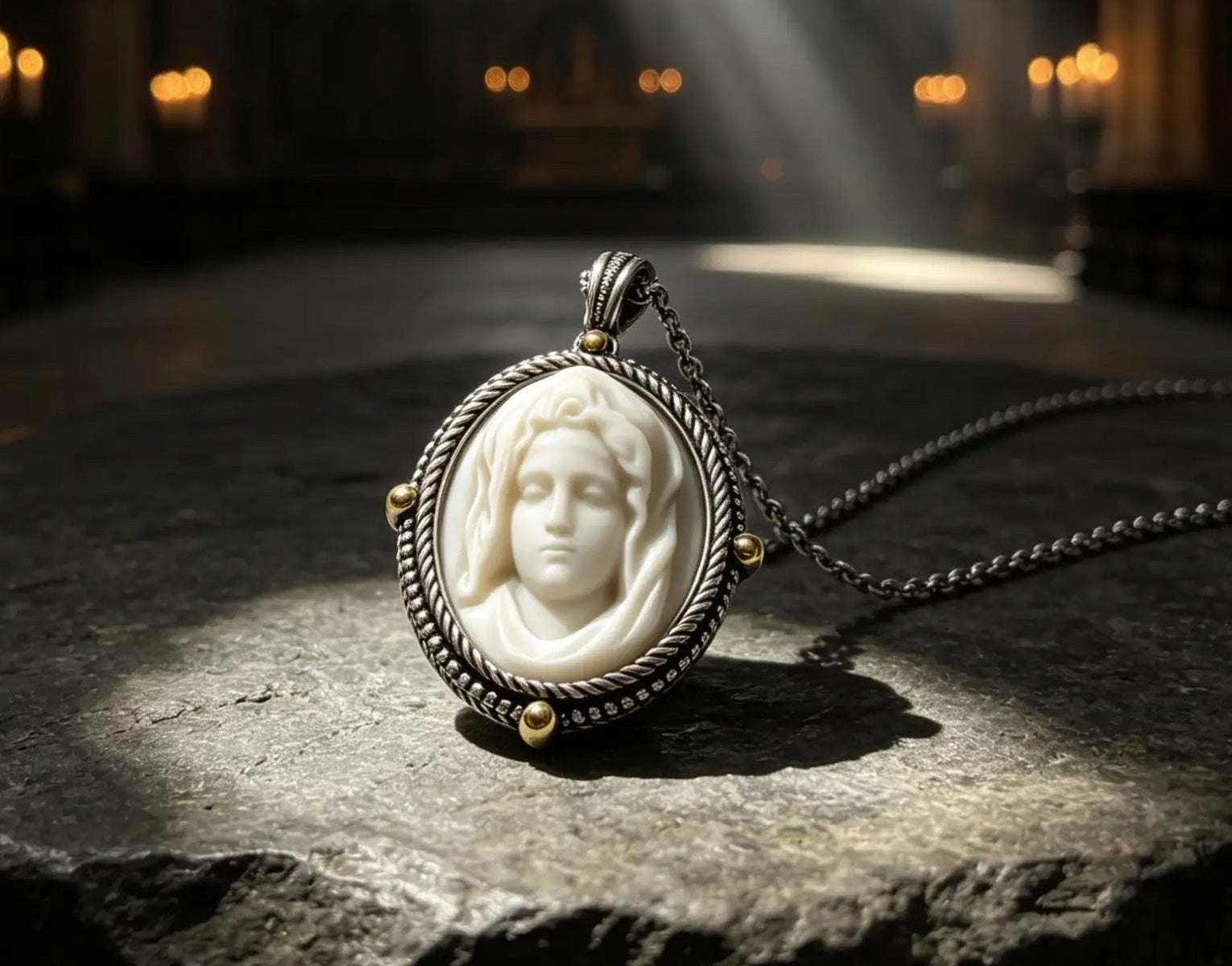 A silver-toned oval pendant necklace with a carved ivory face medallion, displayed on a stone surface in a cathedral interior with dramatic light rays from a stained glass window.