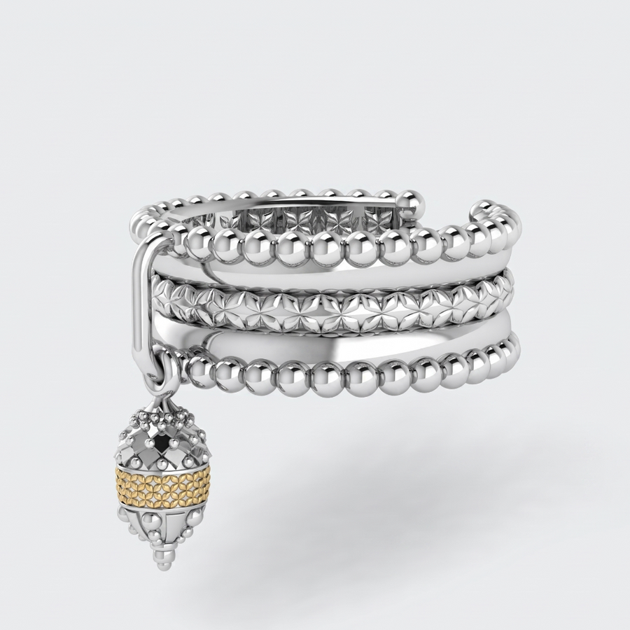 A silver-toned multi-band cuff bracelet with a dangling acorn charm featuring a textured gold band, set against a light gray background.
